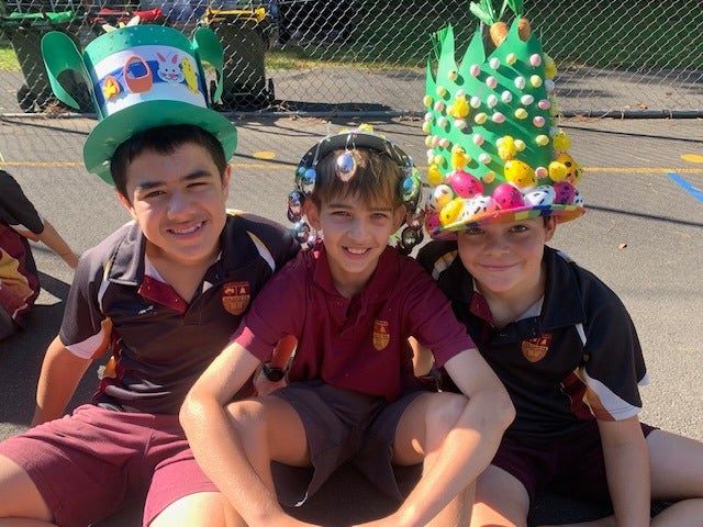 3 boys on ground in Easter hats
