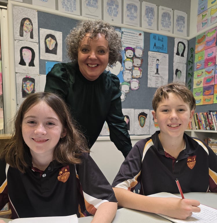 Adult and two children in classroom