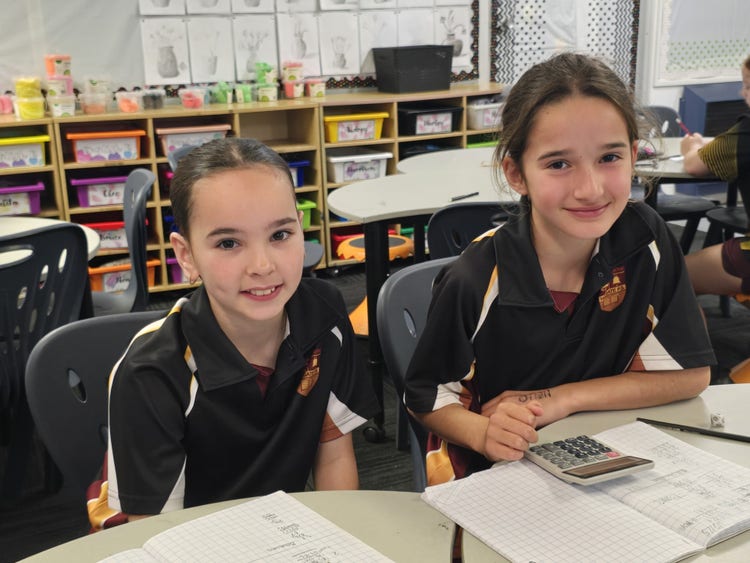 two girls sitting at desk