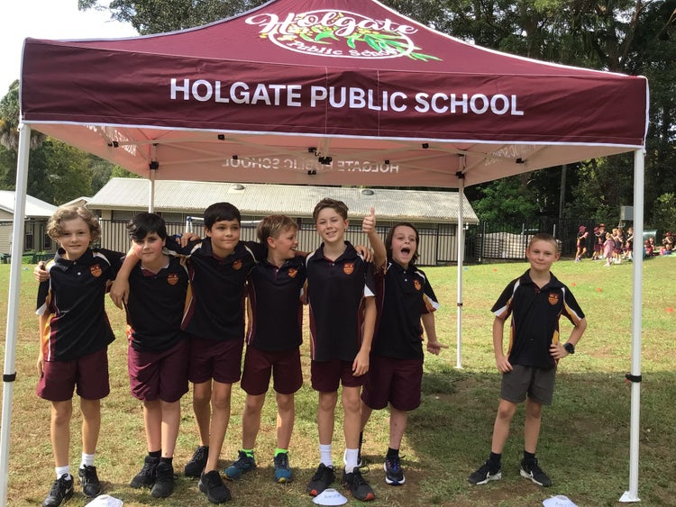 Boys standing under marquee during Cross Country